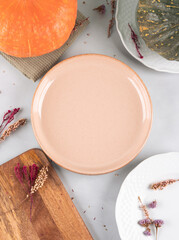 Fall thanksgiving table setting pumpkin decor flatlay with pink dish