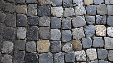 Obraz premium Full frame texture of an ancient Roman or European cobblestone pavement, featuring small, square stones in various shades of gray, black, and brown, laid in an irregular pattern.
