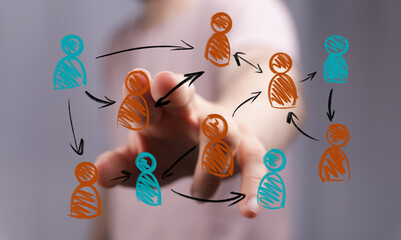 A human hand interacts with a vibrant digital display illustrating a complex network of connected people icons. Represents teamwork, social netw
