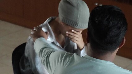 South Asian cancer patient, young woman cancer patient crying after chemotherapy treatment, receiving family or friend support and encouragement  