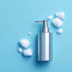 Obraz premium A sleek silver pump bottle dispensing foamy soap against a blue backdrop, conveying cleanliness and hygiene