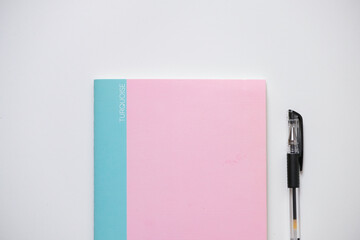 A notebook and a pen isolated on a white background