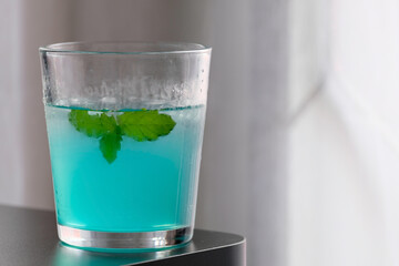 Refreshing blue iced drink with mint leaves