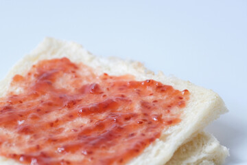 Close-up of white bread with raspberry jam