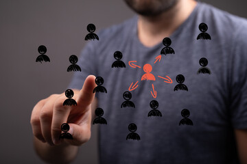Image depicts a man choosing a central figure from a network of people, highlighting leadership,...