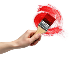 Human hand holding a paintbrush, creating a curved red brushstroke on black