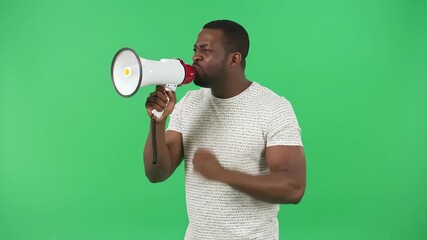 Energetic African American man passionately shouting into a megaphone on a green screen, making a powerful announcement - Powered by Adobe