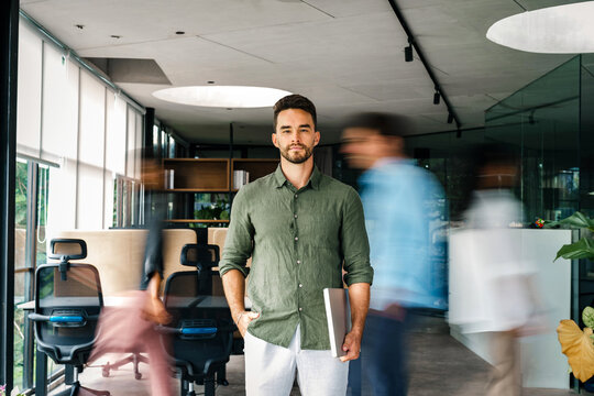 Group of young multi-ethnic startup business team collaborating on project in modern office