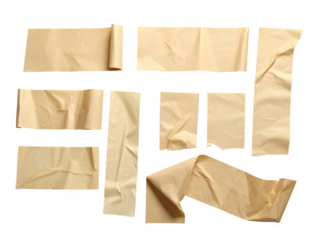 Assorted strips of beige masking tape against a black background