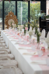 Elegant Private Event Venue Setting Prepared for a Special Lunch Gathering with Luxurious Gold Throne Chair and Delicate Floral Arrangements