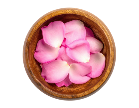 Overhead view of pink rose petals nestled inside a wooden bowl