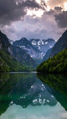 Mountain lake reflecting dramatic sky