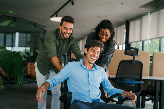 Group of young multi-ethnic startup business team collaborating on project in modern office - Powered by Adobe