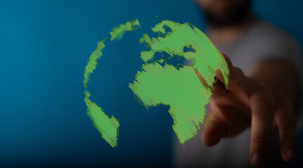 Conceptual image of a hand interacting with a glowing green digital globe, symbolizing global communication, sustainability, technology, and a c