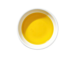 Overhead view of a bright yellow liquid in a small, round, white ceramic bowl