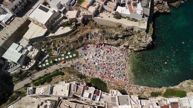 Aerial View of Polignano a Mare with Historic Buildings and Crowded Beach, Puglia, Southern Italy
