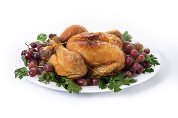 Roast turkey with grapes and parsley on white plate isolated on white background