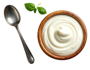 Overhead view of creamy white food in a wooden bowl with a spoon and basil