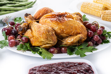Thanksgiving dinner on rustic wooden table with turkey,mashed potatoes,ears of corn and green bean casserole