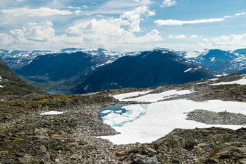 Obraz premium Views from the top of Dalsnibba which is Europe’s highest fjord viewpoint at 1500 meters of altitude, with spectacular views over Geiranger fjord and the village and the eternal snow fields