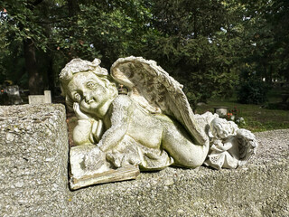 Angel figurine on a tombstone in the public cemetery