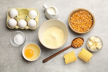 Cornbread preparation. Different ingredients on light grey table, flat lay