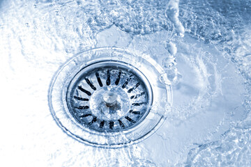 Water going down sink drain, closeup view