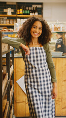 Portrait Of Confident Young Woman Wearing Apron Working In Food Shop Or Cafe