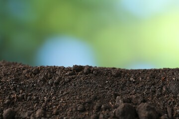 Pile of fresh soil on blurred background, closeup