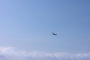 Airplane flying in beautiful blue sky, bottom view