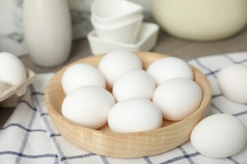Raw chicken eggs and towel on counter, closeup