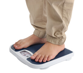 Boy standing on scales against white background, closeup