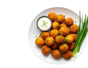 Crispy, golden-brown fried food balls with dipping sauce and chives on a white plate