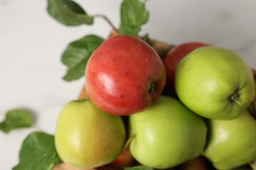 Fresh ripe apples in crate on white table, closeup