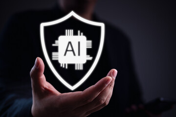 AI security concept. Businessman hand holding glowing shield with AI chip icon, symbolizing artificial intelligence protection, cybersecurity, and trustworthy technology in digital systems.