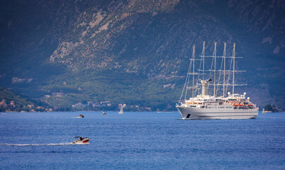 White Sailing Yacht  Wind Surf entering Kotor Bay in Montenegro with dramatic mountains in the...