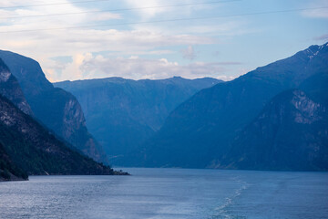 Amazing sunset views of the Sognefjord in Norway during a amazing Summer evening seen from the backside of a ship, when cruising through the unique natural landscape of Norway and its fjords, while th