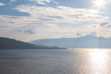 Amazing sunset views of the Sognefjord in Norway during a amazing Summer evening seen from the backside of a ship, when cruising through the unique natural landscape of Norway and its fjords, while th