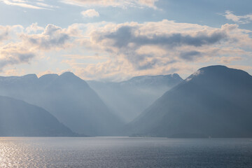 Amazing sunset views of the Sognefjord in Norway during a amazing Summer evening seen from the backside of a ship, when cruising through the unique natural landscape of Norway and its fjords, while th