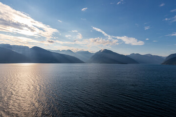 Amazing sunset views of the Sognefjord in Norway during a amazing Summer evening seen from the backside of a ship, when cruising through the unique natural landscape of Norway and its fjords, while th