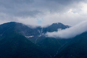 Amazing sunset views of the Sognefjord in Norway during a amazing Summer evening seen from the backside of a ship, when cruising through the unique natural landscape of Norway and its fjords, while th