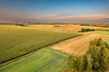 Aerial View of Vast Farmland With Distant Heaps, Poland &ndash; Countryside Fields and Summer Light