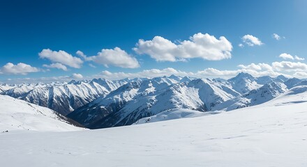 Snow covered mountain range under a clear blue sky with scattered clouds