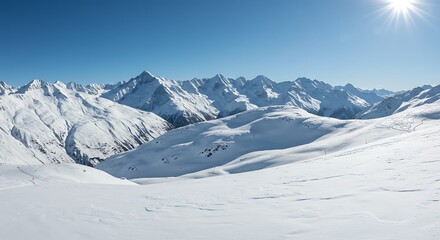 Snow covered mountain range under bright sunlight in clear blue sky