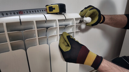 Central heating mechanic and handyman fixing home radiator, gas crisis and seasonal issues.