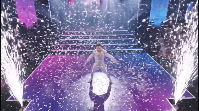 Person celebrating on stage with confetti and fireworks, perfect for adding excitement and energy to event promotions or entertainment materials.