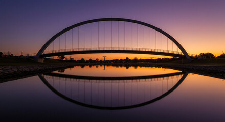 Fototapeta premium Arch bridge reflection at sunset