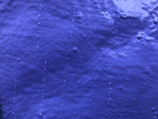 Purple violet blue paint graffiti rough texture wall wallpaper background close-up