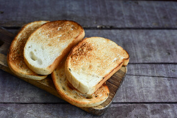 White bread toasted on an outdoor Grill on wooden table