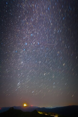 In the clear dawn before sunrise, the autumn constellations rise with shooting star. (cassiopeia, andromeda, perseus and milky way)